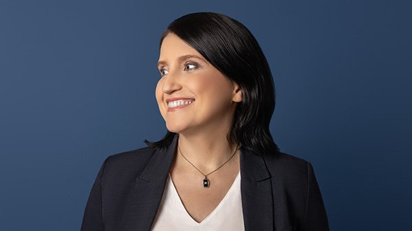 A woman in a white shirt and black jacket