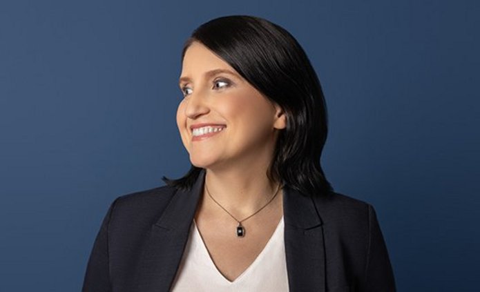 A woman in a white shirt and black jacket